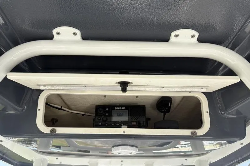Slide: The Image of 2022 Robalo R242 Center Console boat interior with speaker and rod holders. - 15
