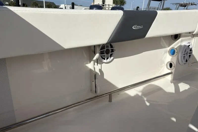 Slide: The Image of 2022 Robalo R242 Center Console boat interior with rod holders and Yeti cooler. - 16