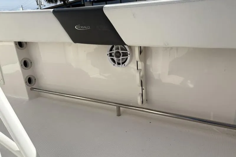 Slide: The Image of 2022 Robalo R242 Center Console boat seating with dual-tone upholstery and helm station. - 17