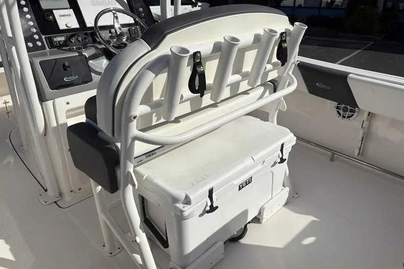 Slide: The Image of 2022 Robalo R242 Center Console boat dashboard with steering wheel and Simrad electronics. - 18