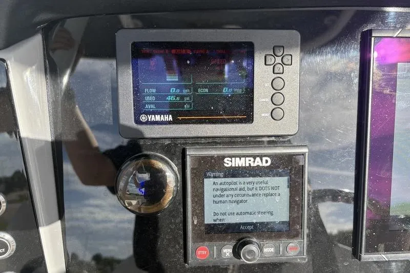 Slide: The Image of Clarion audio system on 2022 Robalo R242 Center Console boat dashboard. - 21