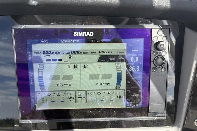 Slide: The Image of 2022 Robalo R242 Center Console boat interior with storage compartment and railing. - 22