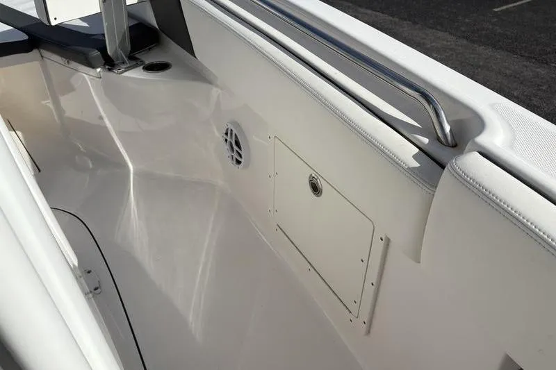 Slide: The Image of 2022 Robalo R242 Center Console boat interior with white seating and modern design. - 24