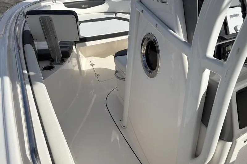 Slide: The Image of 2022 Robalo R242 Center Console boat interior with cushioned seating and storage. - 25