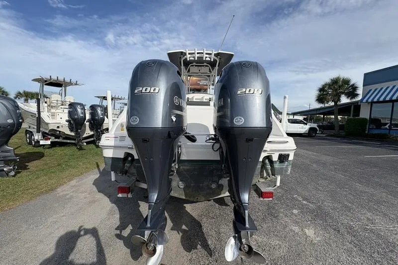 Slide: The Image of 2022 Robalo R242 Center Console boat with Yamaha engine on trailer, outdoor setting. - 3