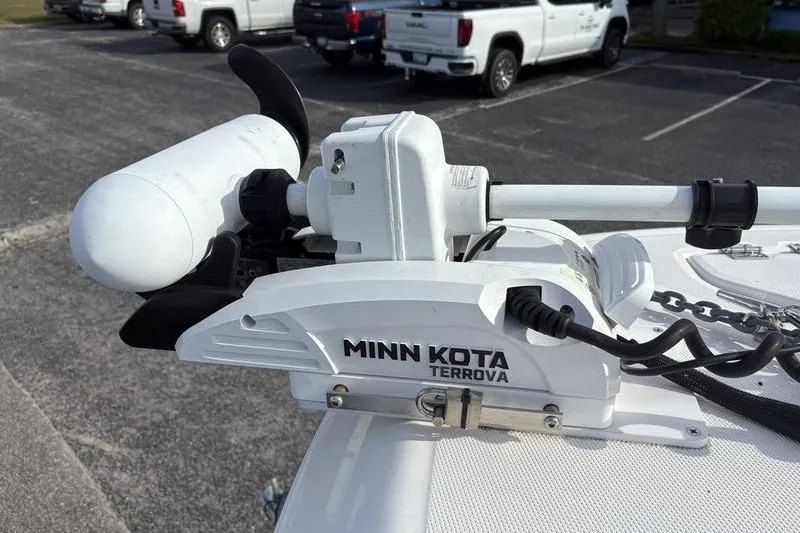 Slide: The Image of 2022 Robalo R242 Center Console boat in a marina, covered seats, sunny day. - 30