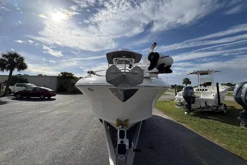 Slide: The Image of 2022 Robalo R242 Center Console boat on trailer under sunny sky. - 7