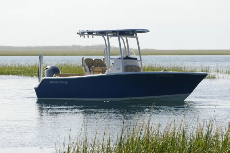 Slide: The Image of 2023 Sportsman Heritage 211 Center Console boat on calm water. - 1