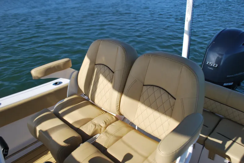 Slide: The Image of 2023 Sportsman Heritage 211 Center Console boat seats with diamond stitching on water. - 13