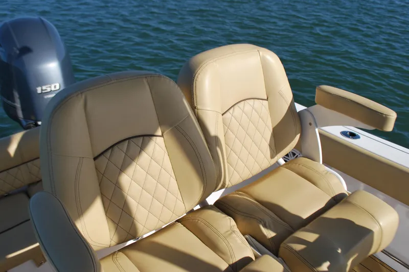 Slide: The Image of 2023 Sportsman Heritage 211 Center Console boat seats with diamond stitching, on water. - 14