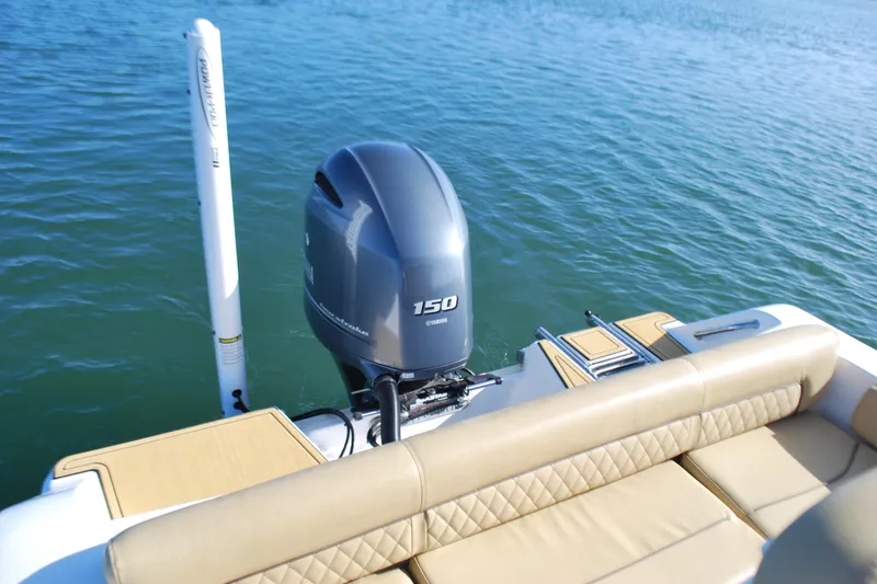 Slide: The Image of 2023 Sportsman Heritage 211 Center Console boat with Yamaha 150 engine on water. - 18