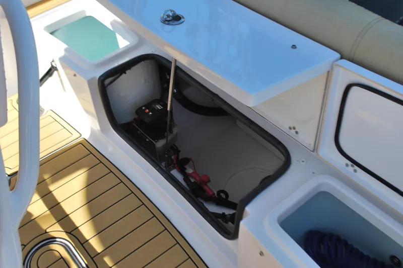 Slide: The Image of 2023 Sportsman Heritage 211 Center Console storage compartment with battery and accessories. - 19