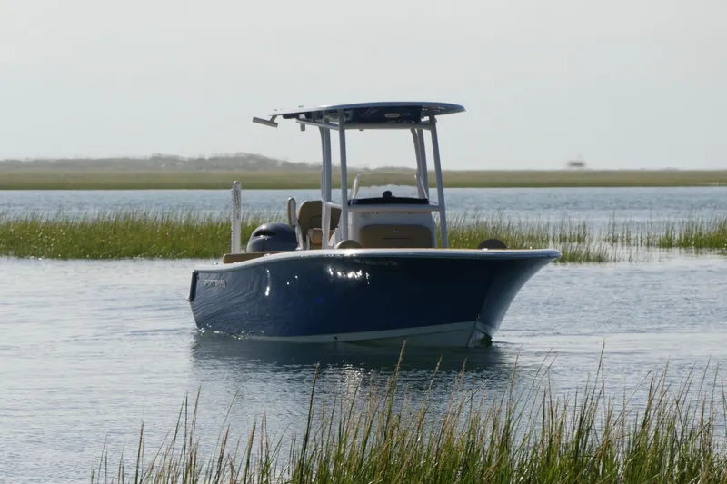Slide: The Image of 2023 Sportsman Heritage 211 Center Console boat on calm water. - 2