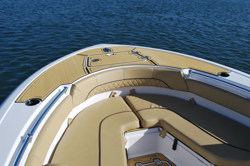 Slide: The Image of 2023 Sportsman Heritage 211 Center Console boat interior with tan seating on water. - 5