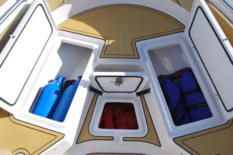 Slide: The Image of 2023 Sportsman Heritage 211 Center Console storage compartments with life jackets and gear. - 7