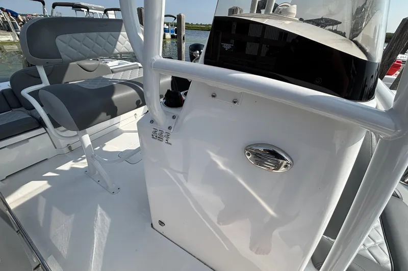Slide: The Image of 2024 NauticStar 222OSL boat interior with gray seating and console details. - 10