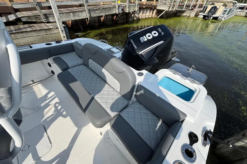 Slide: The Image of 2024 NauticStar 222OSL boat interior with seating and Mercury engine by the dock. - 3