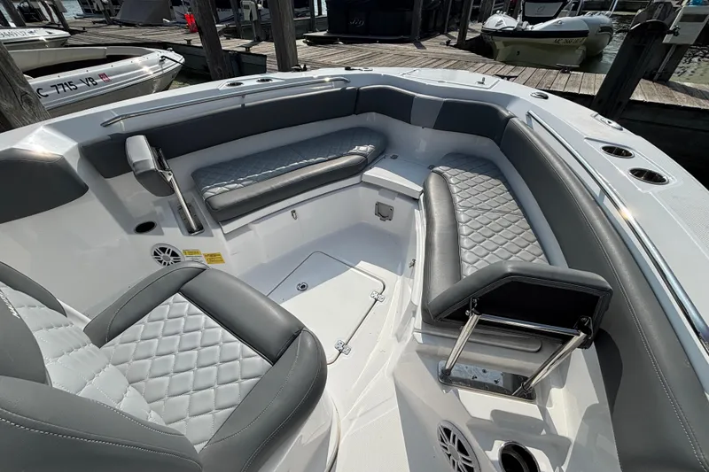 Slide: The Image of 2024 NauticStar 222OSL boat interior with gray quilted seating and cup holders. - 9