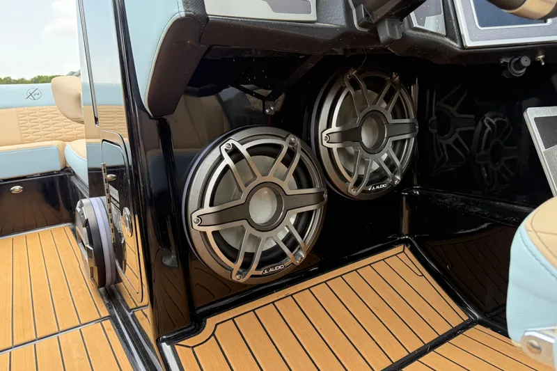 Slide: The Image of 2022 MasterCraft X24 boat interior with JL Audio speakers and teak flooring. - 13