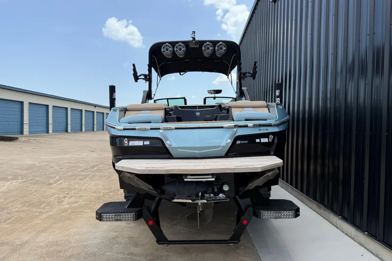 Slide: The Image of 2022 MasterCraft X24 boat parked near storage units, rear view. - 5