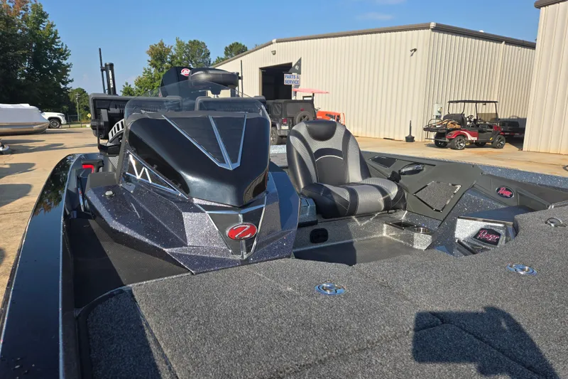 Slide: The Image of 2020 Ranger Z521L boat with sleek design, parked outdoors near a service building. - 16