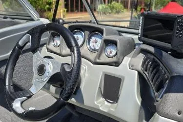Slide: The Image of 2019 Tracker Targa V-18 Combo boat dashboard with steering wheel and gauges. - 2