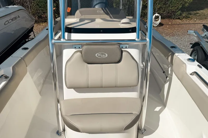 Slide: The Image of 2021 Key West 203 FS boat interior with beige seating and chrome details. - 11
