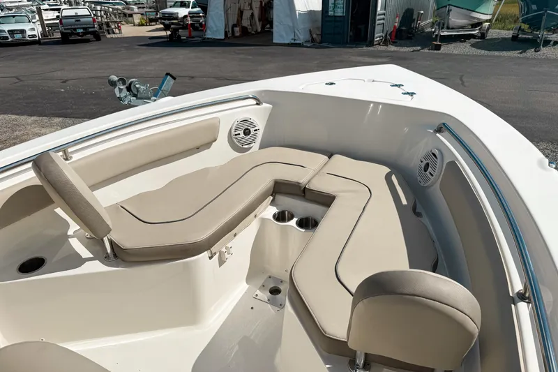 Slide: The Image of 2021 Key West 203 FS boat interior with beige seating and cup holders. - 12