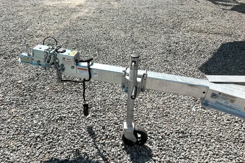 Slide: The Image of Trailer hitch and jack stand on gravel for 2021 Key West 203 FS boat. - 14