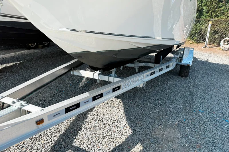 Slide: The Image of 2021 Key West 203 FS boat on Venture trailer, parked on gravel. - 16