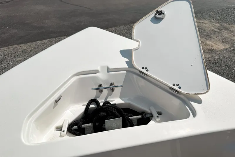 Slide: The Image of Open storage compartment on 2021 Key West 203 FS boat, showing coiled rope inside. - 17