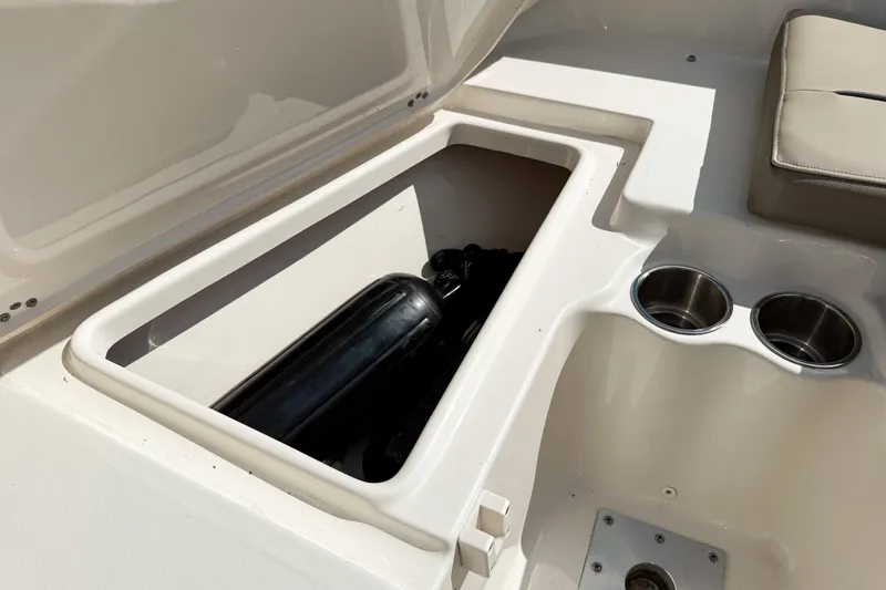 Slide: The Image of 2021 Key West 203 FS boat storage compartment with cup holders and seating. - 22