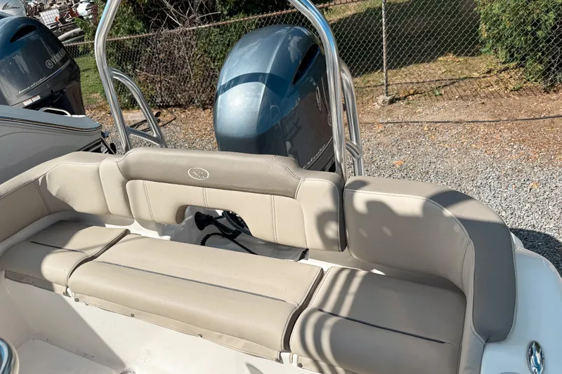 Slide: The Image of 2021 Key West 203 FS boat with beige seating and outboard motor. - 5