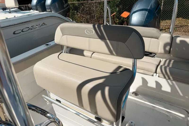 Slide: The Image of 2021 Key West 203 FS boat interior with beige seating and visible Cobia branding. - 6