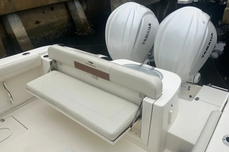 Slide: The Image of 2024 Cobia 280 Center Console boat with Yamaha engines and cushioned seating. - 14