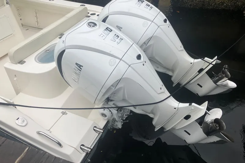 Slide: The Image of 2024 Cobia 280 Center Console with twin Yamaha outboard engines. - 6