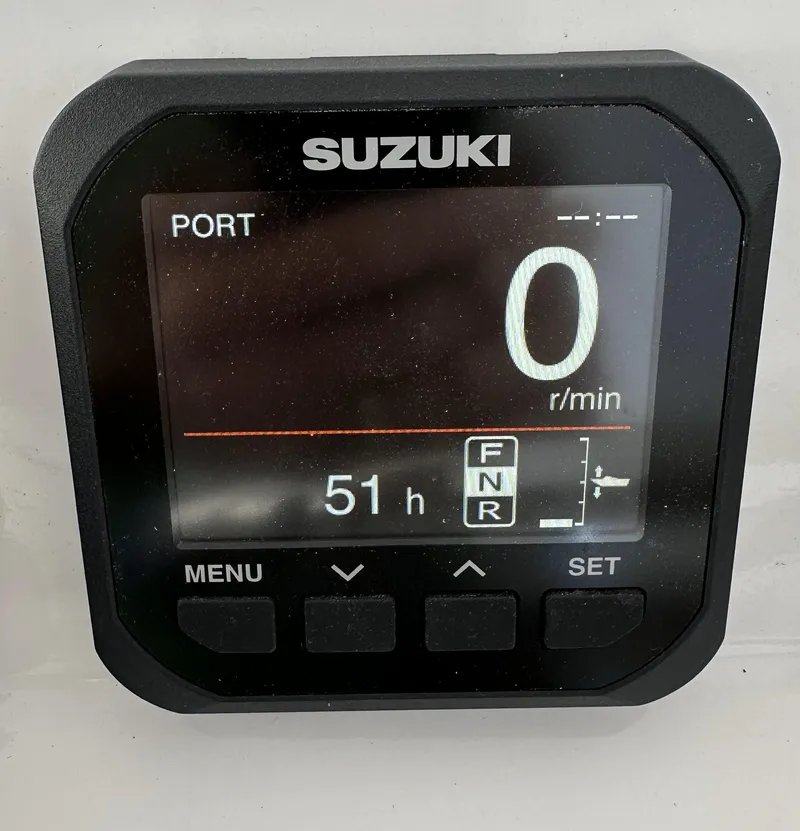 Slide: The Image of Suzuki digital display showing 0 RPM and 51 hours on a Custom Carolina Express 2019. - 14
