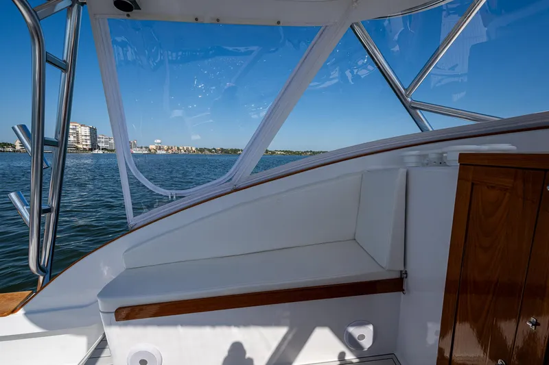 Slide: The Image of 2019 Custom Carolina Custom Express boat interior with ocean view and clear blue sky. - 16