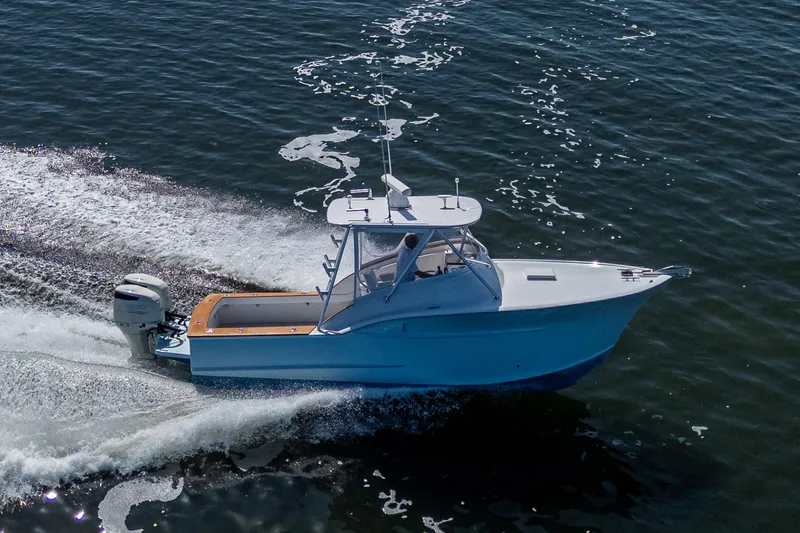 Slide: The Image of 2019 Custom Carolina Custom Express boat cruising on open water. - 30