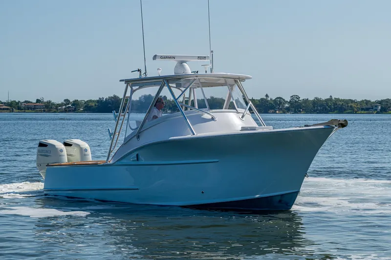 Slide: The Image of 2019 Custom Carolina Custom Express boat cruising on calm waters. - 38