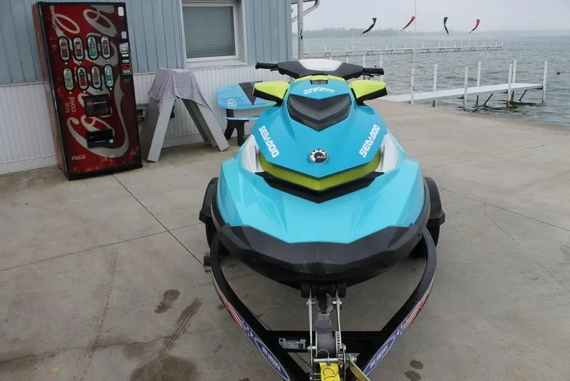Slide: The Image of 2015 Sea-Doo GTI SE 155 jet ski parked near a lakeside dock. - 5