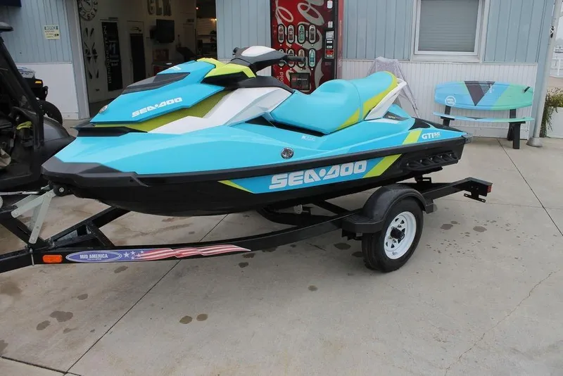 Slide: The Image of 2015 Sea-Doo GTI SE 155 jet ski on trailer, parked outside a building. - 6