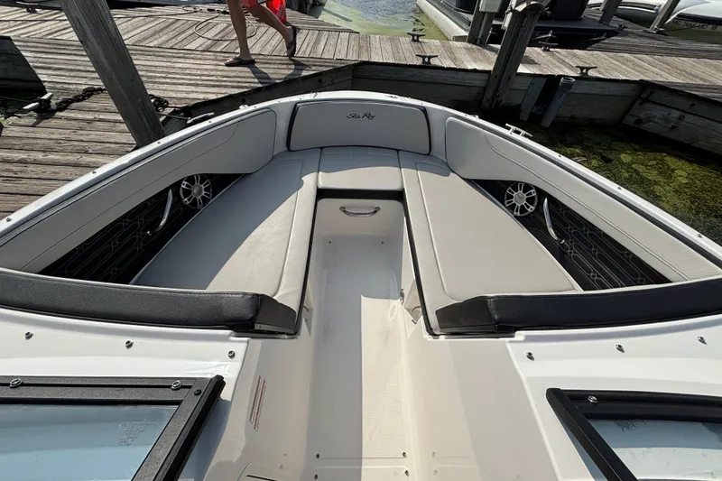 Slide: The Image of 2024 Sea Ray SPX 210 Outboard boat interior with cushioned seating and sleek design. - 3