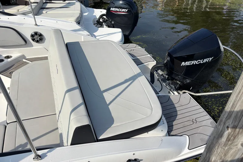Slide: The Image of 2024 Sea Ray SPX 210 Outboard boat with Mercury engine, docked on calm water. - 7