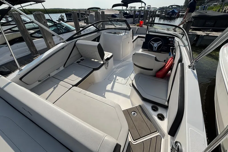 Slide: The Image of 2024 Sea Ray SPX 210 Outboard boat interior with sleek seating and modern dashboard. - 9