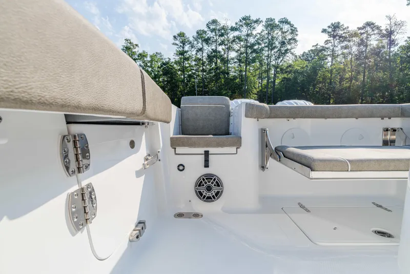 Slide: The Image of 2026 Sea Hunt Gamefish 25 boat interior with cushioned seating and speaker system. - 10