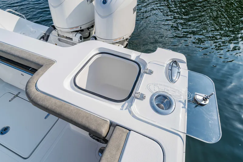 Slide: The Image of 2026 Sea Hunt Gamefish 25 boat with open storage compartment and dual engines. - 12