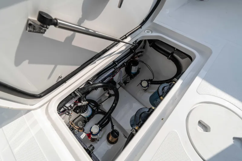 Slide: The Image of Open hatch of 2026 Sea Hunt Gamefish 25 showing internal components and wiring. - 17