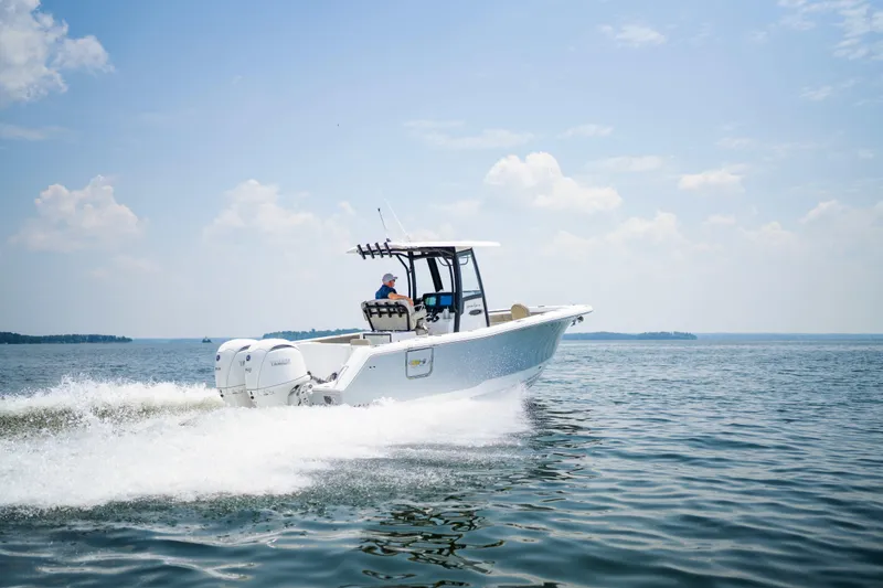 Slide: The Image of 2026 Sea Hunt Gamefish 25 cruising on open water under a clear sky. - 21