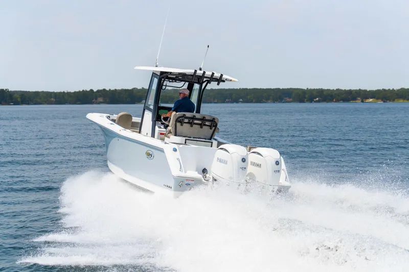 Slide: The Image of 2026 Sea Hunt Gamefish 25 speeding on open water, twin Yamaha engines visible. - 23